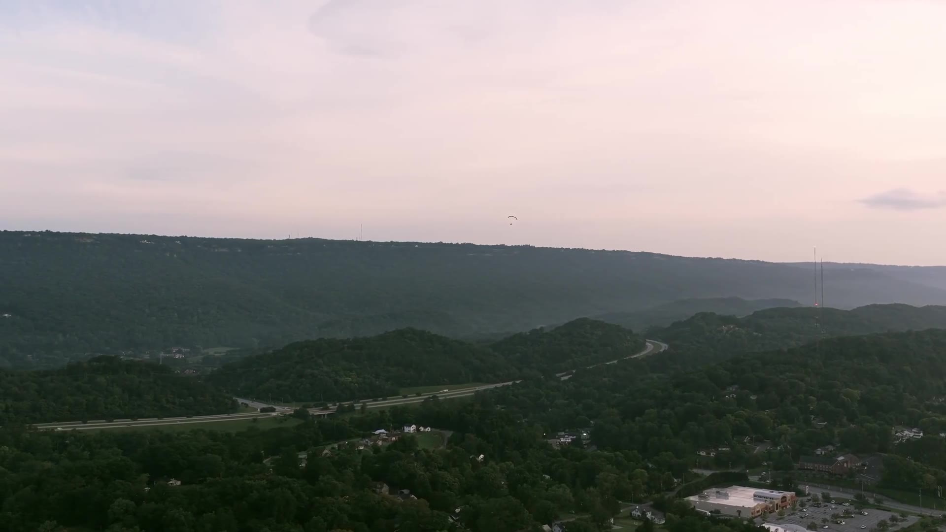 Aerial view over forested Virginia ridgelines at dusk